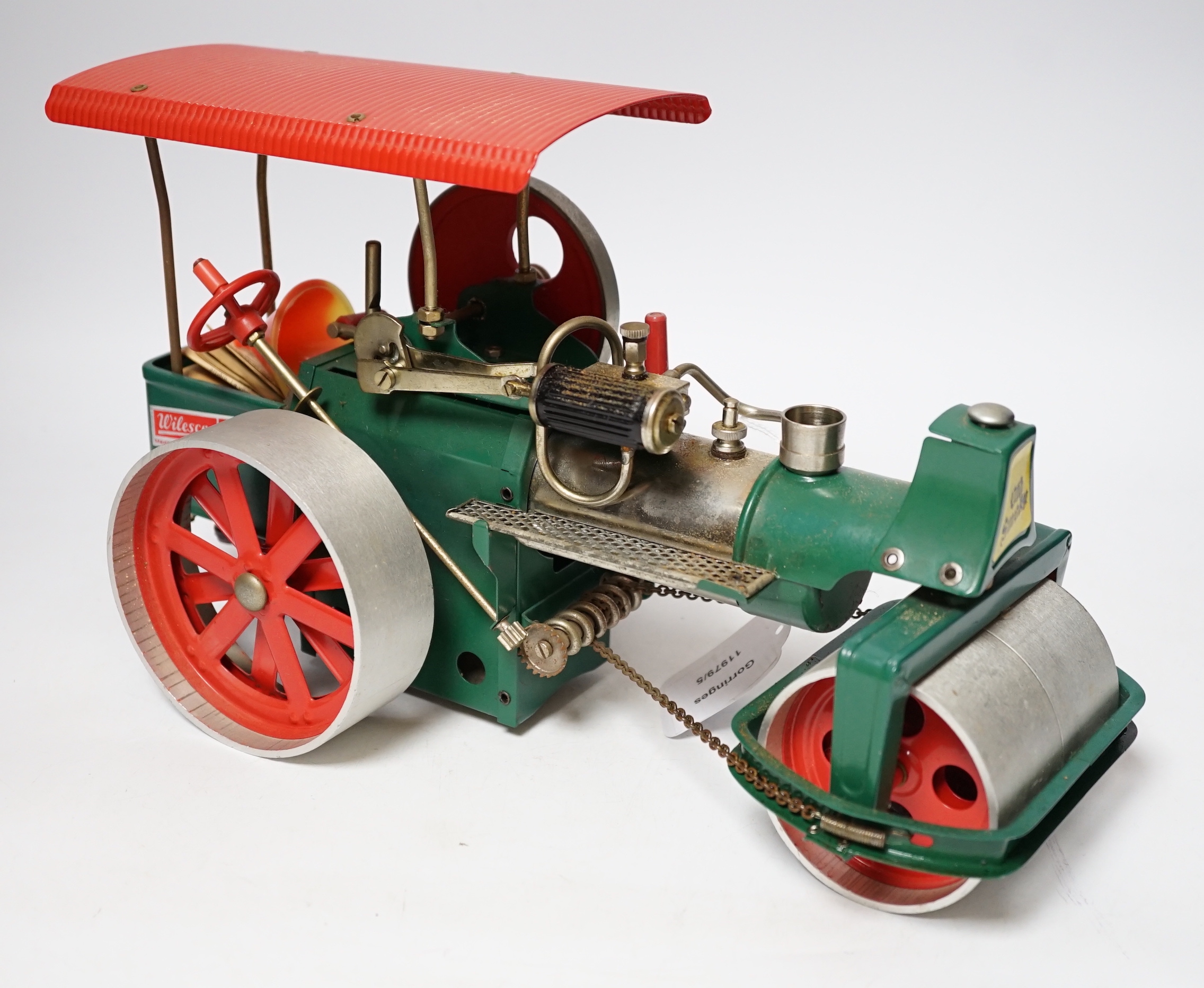 A Wilesco live steam tinplate and aluminium model Road Roller, missing its chimney